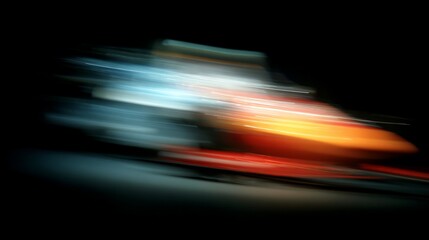 Naklejka premium A blurred, abstract image of a fast-moving object with streaks of orange, white, and blue