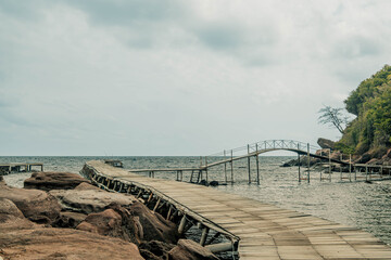 Obraz premium Rustic Wooden Pier and Arched Bridge on the Coast of Phu Quoc Vietnam