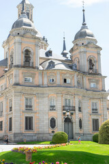 Fototapeta premium Historic building with towers and colorful flowers.. Royal Palace of La Granja de San Ildefonso, Spain