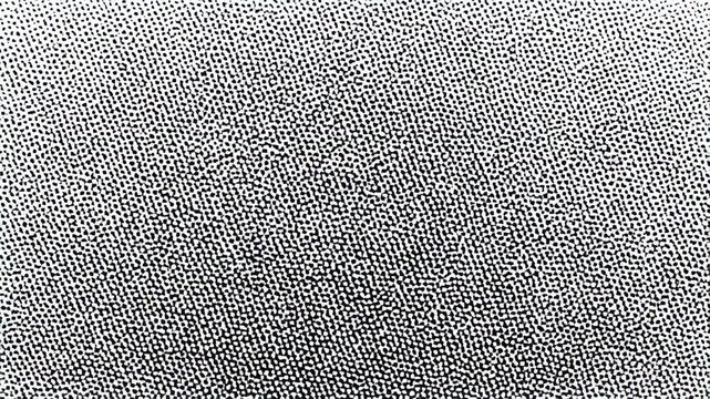 Abstract animated background of tiny white dots forming a pattern on black, subtle texture