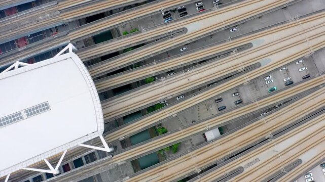 Aerial View of Train Station with Multiple Tracks and Parked Vehicles