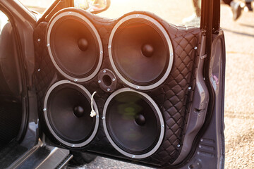 Fototapeta premium Car Door Trimmed In Quilted Leather With Four Large Speakers. Powerful Custom Auto Sound Equipment.