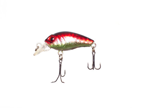 Brightly colored fishing lure, red and green, with two sharp treble hooks and clear plastic lip, isolated against pristine white background
