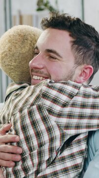 Portrait of good-natured joyful sweet loving 25-aged male lovers which looking into eyes each other with tenderness and then hugging each other thus expressing their commitment