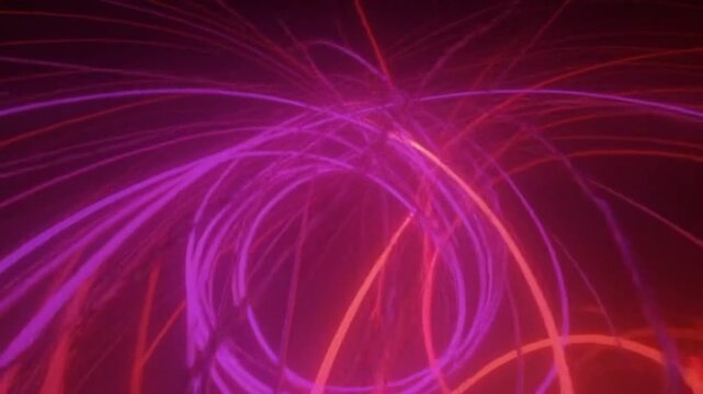 Dynamic abstract light trails move and intersect creating vibrant energy flow across dark background in seamless loop