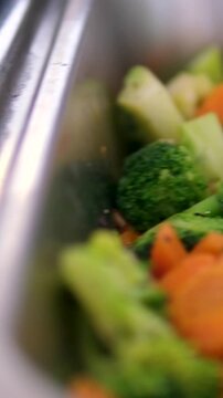 Broccoli carrots tongs Fresh broccoli in plate. Healthy food, vegetarian cuisine. 
