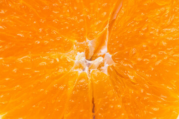 Macro Shot of Fresh Sliced Orange Fruit Texture,A vibrant, high-angle macro close-up showing the detailed texture of a fresh orange slice. The image highlights the juicy pulp, segments, and organic. © banjongseal324