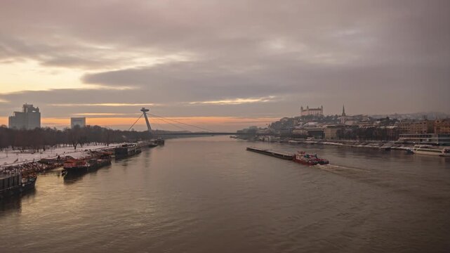 Bratislava Old Town and SNP Bridge over Danube River at sunset time lapse, Slovakia.