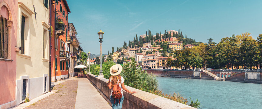 Traveler girl with hat and bag visiting Verona city in Italy