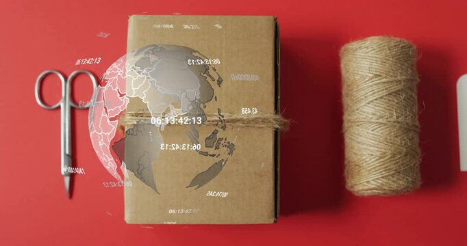 Packaging setup showing scissors box spool gift tag while digital globe fading, spinning for data