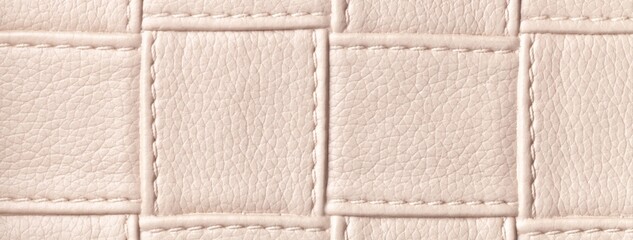 Fototapeta premium Texture light cream leather background with quilted stitched pattern, macro. Abstract pastel beige upholstery surface