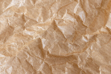 Obraz premium Crumpled brown kraft paper creating textured background