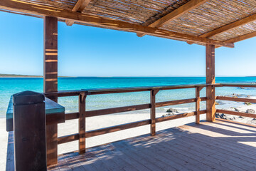 Wooden porch by the sea in Sardinia on a sunny spring day