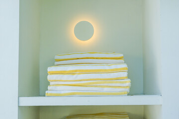 Yellow folded striped beach towel at swimming pool,sea beach, gym fitness in resort hotel,concept...