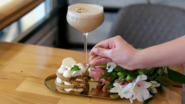 Dessert spoon flowers beautiful breakfast, dessert with airy white cream, coffee drink, white and pink orchid flowers in glass on wooden table, a wonderful dessert in a luxury restaurant