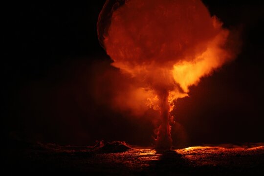 Flames rise from a nuclear bomb explosion mushroom cloud