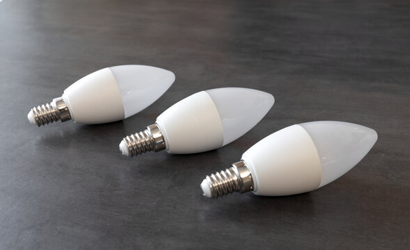 LED candle lamp.Three white plastic lamps with an e14 base.