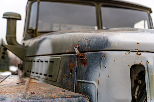 View of a vintage military truck with peeling paint and rust, revealing a history etched in metal, standing stoically, Kyiv, Kyiv, Ukraine.