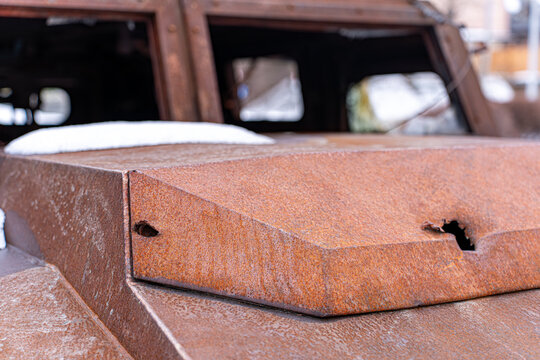 View of a rusted armored vehicle, scarred by battle, stands as a stark monument against the pale sky, a solemn reminder in Kyiv, Kyiv, Ukraine.
