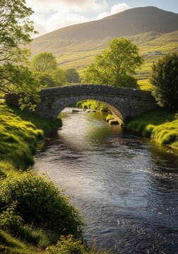 Stone Arch Bridge Over Stream in Green Valley Landscape
