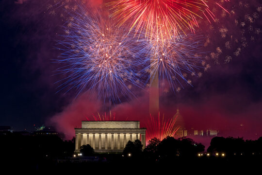 July 4th Independence Day fireworks display over the Washington DC skyline at night.