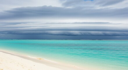 Fototapeta premium Tropical Beach With Azure Water And Moody Sky In Bright Daylight