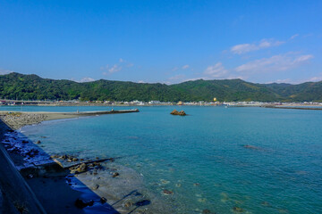 Obraz premium Calm Coastal Bay and Breakwater Landscape in Shikoku Japan