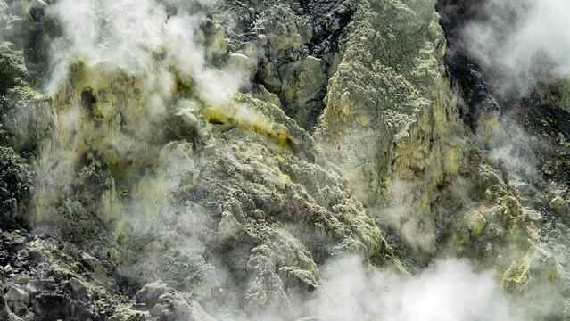 A volcano crater with an acid lake (explosion lake) and steaming fumaroles and hot springs. Sulawesi. Indonesia