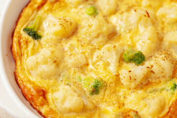 Broccoli cauliflower egg omelette in a plate on the table. Diet nutrition