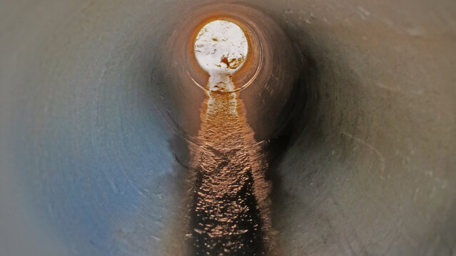 Inside the culvert with a stream.