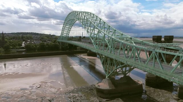 Liverpool, Merseyside, UK, September 09, 2025; aerial 4K video footage of the Silver Jubilee Bridge and Britannia Railway Viaduct over the River Mersey and Manchester Ship Canal, Runcorn, Merseyside