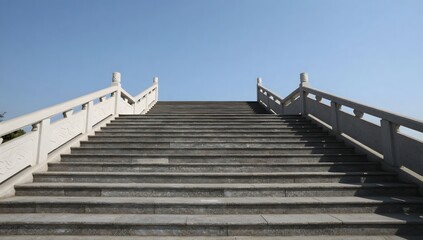Obraz premium Grand stone staircase leading to an unknown destination under a clear sky