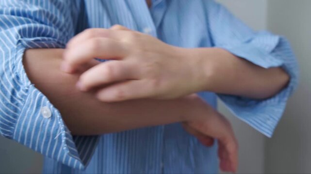 Close up of hand scratching skin early signs of food allergy redness and swelling