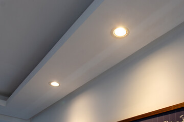 Detail of recessed ceiling lighting with LED spotlights lit in a residential interior. 