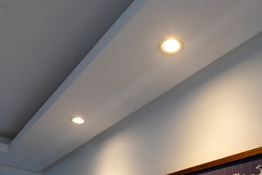 Detail of recessed ceiling lighting with LED spotlights lit in a residential interior. 