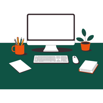 A computer monitor and office supplies on a green desk workspace