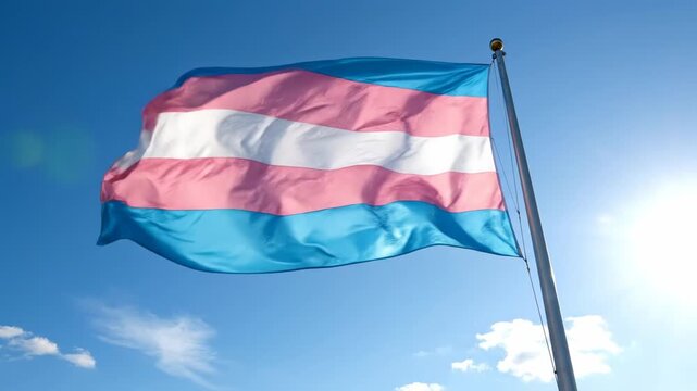 Transgender Pride Flag Waving Proudly Against Blue Sky.