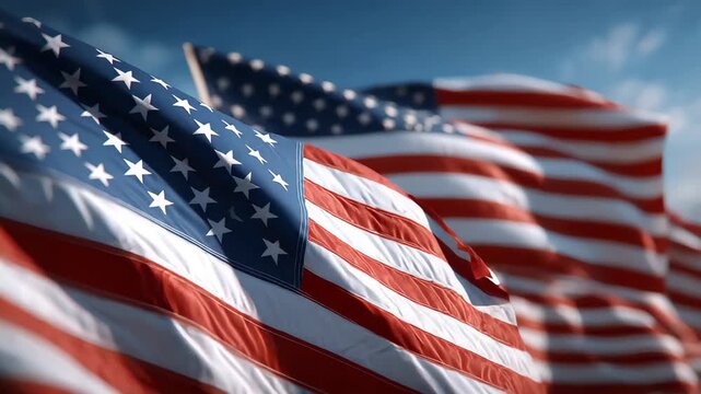 Waving American flags against a bright blue sky captures national pride
