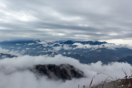 View of dramatic clouds swirl around the rugged mountain peaks, creating an ethereal, dreamlike landscape, Pir Chanasi, Azad Kashmir, Pakistan.