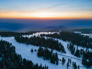 Beautiful winter sunset over the snowy landscape of Kopaonik in Raka District Serbia on a clear evening