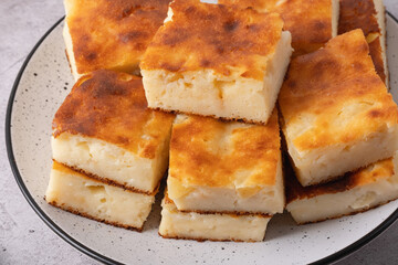 Slices of homemade apple pie lie on a gray plate. Close-up