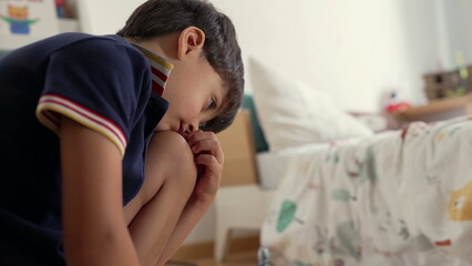 Young boy engaging in imaginative play with toy motorcycle and police car, creative storytelling, childhood fun, independent playtime, cozy bedroom setting © Marco