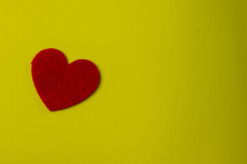Obraz premium Red Felt Heart On Yellow Background