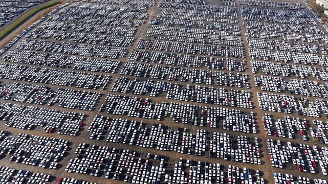 Aerial view of orderly rows of cars in a storage facility, showcasing a sea of vehicles in a structured grid pattern, Grimsby, United Kingdom.