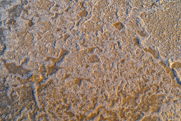 the texture of a mixture of sand, earth, clay, and snow on Lake Elton
