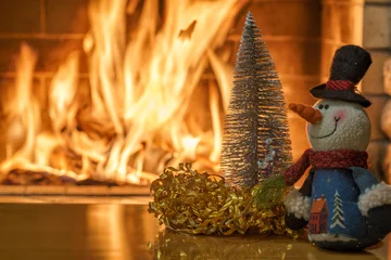 Cozy fireplace,winter vacations, toys before fire burning © larisa_stock