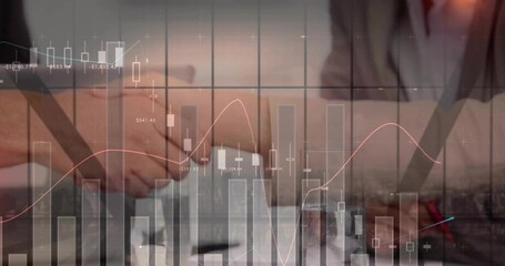 Shaking clasped hands with suit sleeves over office desk showing documents, pen, financial charts