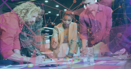 Leaning team in light blazer, checked shirt pointing at sticky notes on meeting table, network