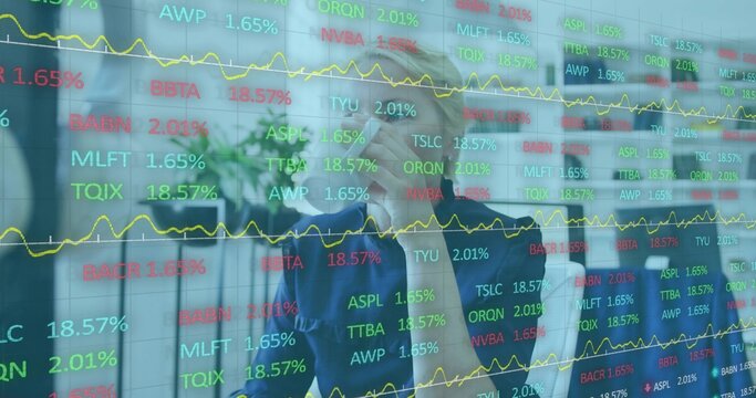Studying senior woman in blazer in office holding tablet and pointing at glass display with tickers