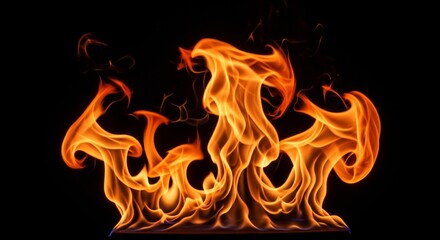 Fototapeta premium Vibrant orange flames burning against a dark background